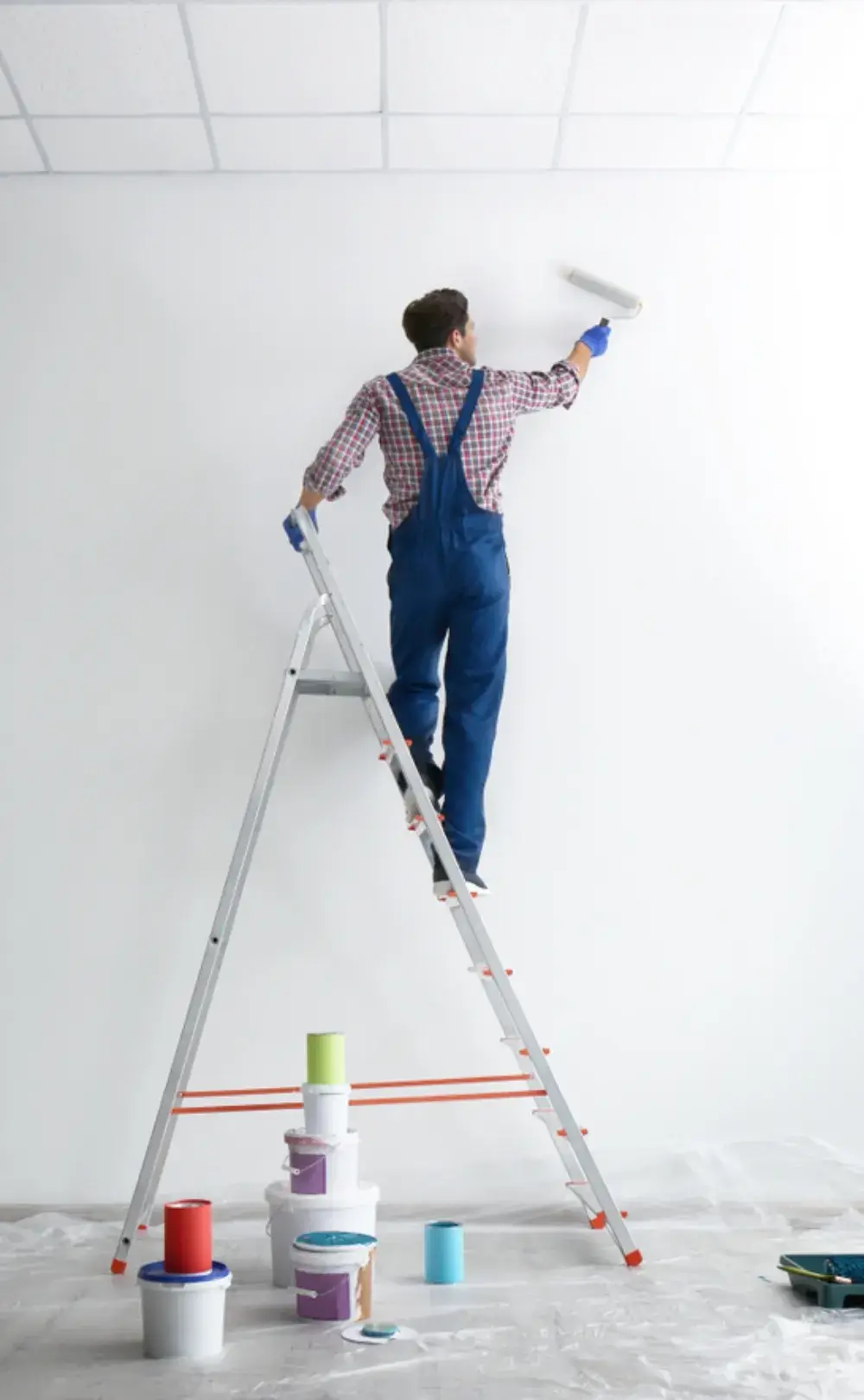 Professional painter applying white paint on wall using roller and ladder – Aghata Painting Services