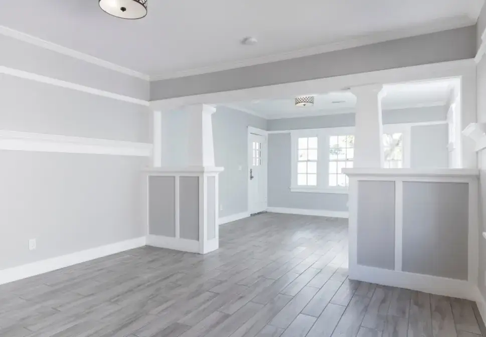 Brightly painted interior living room with soft grey walls and white trim