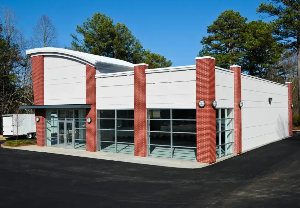 Commercial building exterior freshly painted with red brick and white finishes